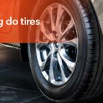Worn vehicle tire showing tread wear indicators that signal the need for replacement.
