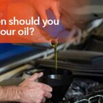 Mechanic changing engine oil during routine vehicle maintenance service.