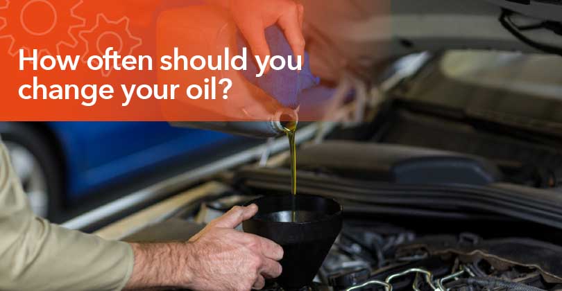 Mechanic changing engine oil during routine vehicle maintenance service.
