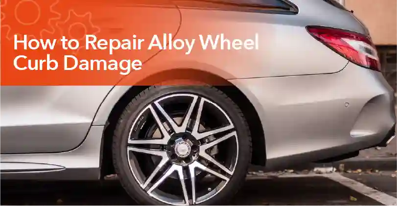 Technician repairing curb damage on an alloy wheel by sanding, filling, and refinishing the rim for a smooth finish.
